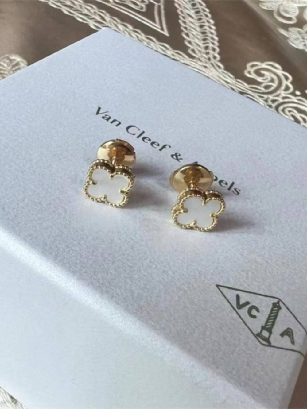 Van Cleef & Arpels white stud earrings.